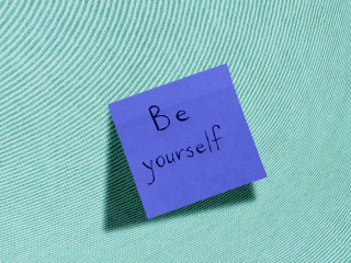 A sticky note that says "be yourself"